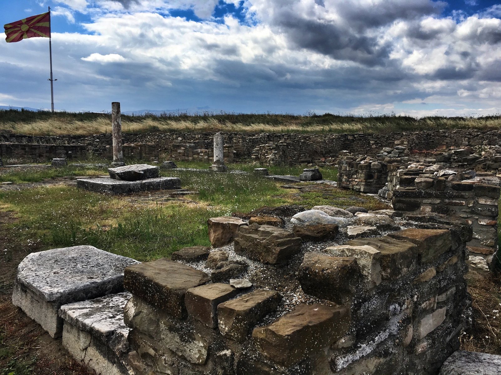 On the Wine Trail in Central Macedonia: Popova Kula, Demir Kapija & Stobi 25 Ruins and Macedonian flag in Stobi, Macedonia © The Blonde Gypsy