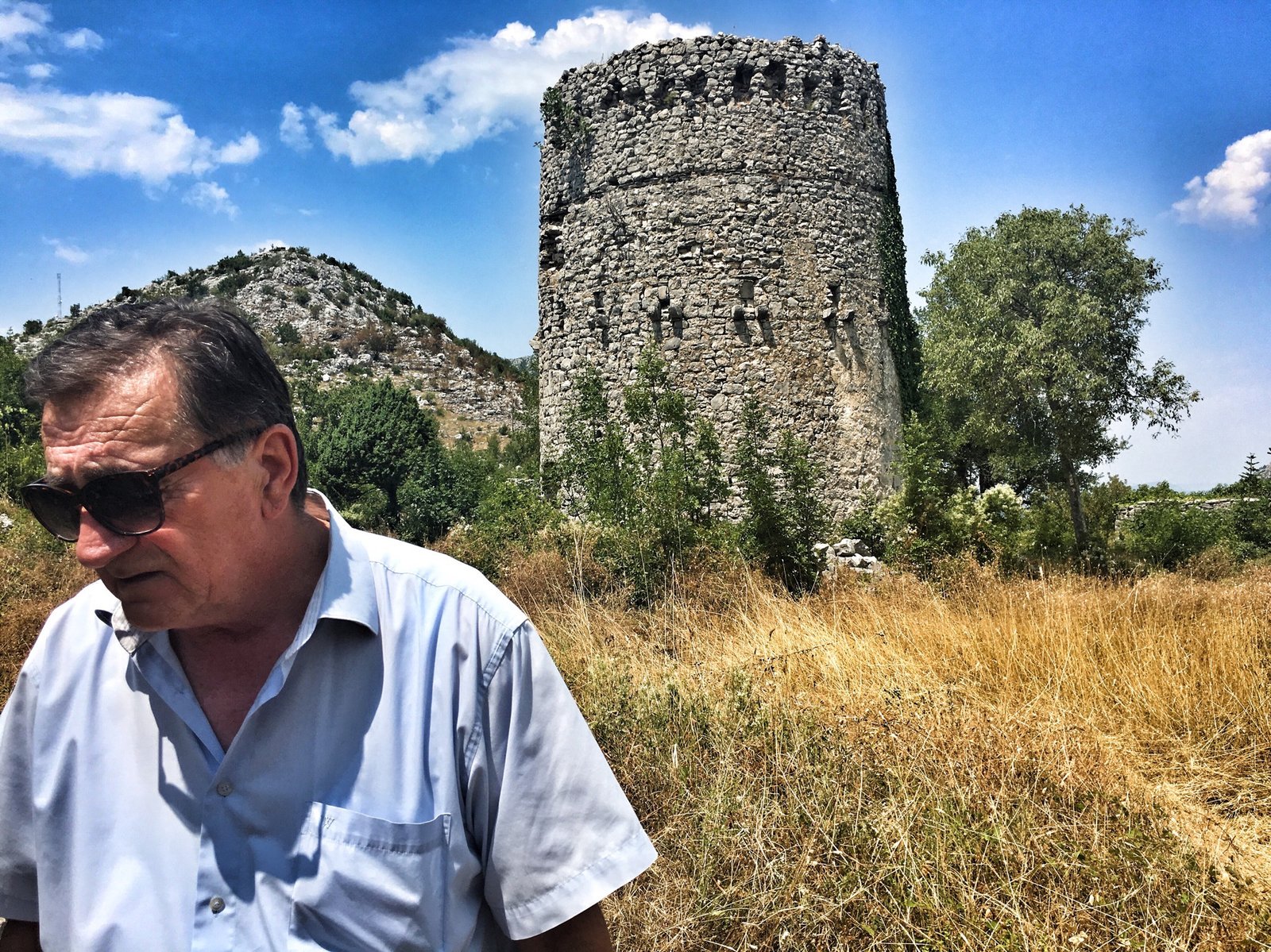 Via Dinarica: Exploring Ravno, Neum, and the Beaches of Bosnia & Herzegovina 25 Historian Stanislav Vukorep at Hadžibegova Kula Fortress near Hutovo, Bosnia & Herzegovina © The Blonde Gypsy