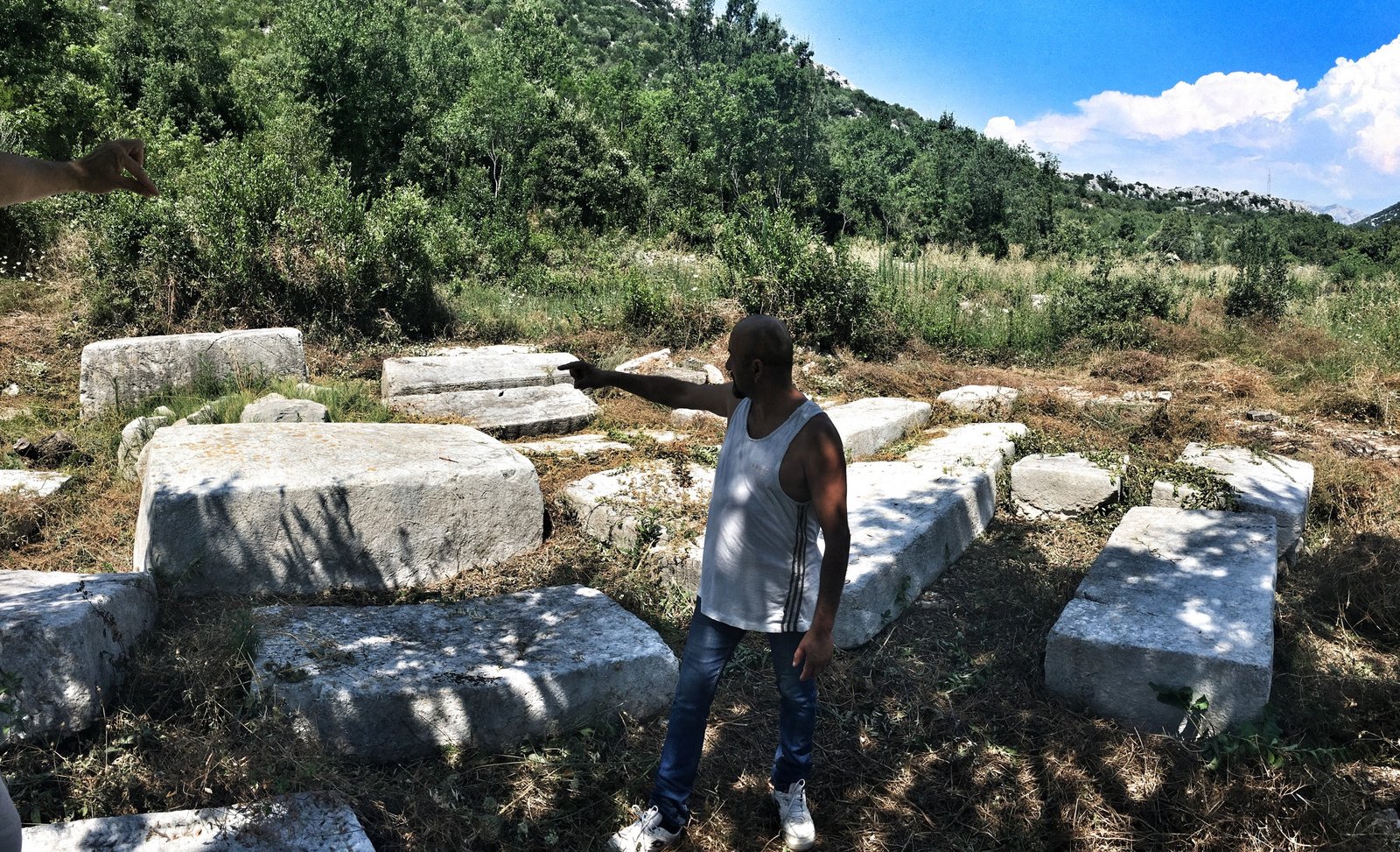 Via Dinarica: Exploring Ravno, Neum, and the Beaches of Bosnia & Herzegovina 17 Local dude showing the way to stecci near Neum, Bosnia & Herzegovina © The Blonde Gypsy